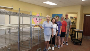 pantry staff standing in classroom with racking