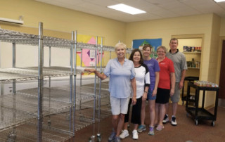pantry staff standing in classroom with racking