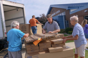 pantry staff unpacking boxes outside of the school