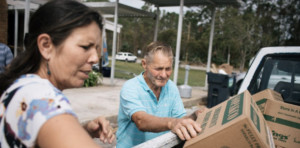 senior man and woman loading boxes into truck
