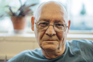 senior man blue shirt wearing glasses