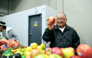 senior man shopping and holding apple