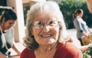 senior woman wearing sweater and glasses