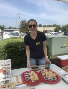 woman nutrition manager lentil taco samples outdoors