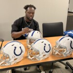 Colts defensive end Kwity Paye signs helmets at Gleaners.