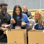 Colts defensive end Kwity Paye helps pack boxes of food in the Gleaners warehouse.
