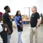 Gleaners CEO shows Colts defensive end Kwity Paye around the Gleaners warehouse.