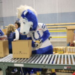 Colts mascot, Blue, helps pack boxes of food for hungry Hoosiers at Gleaners.