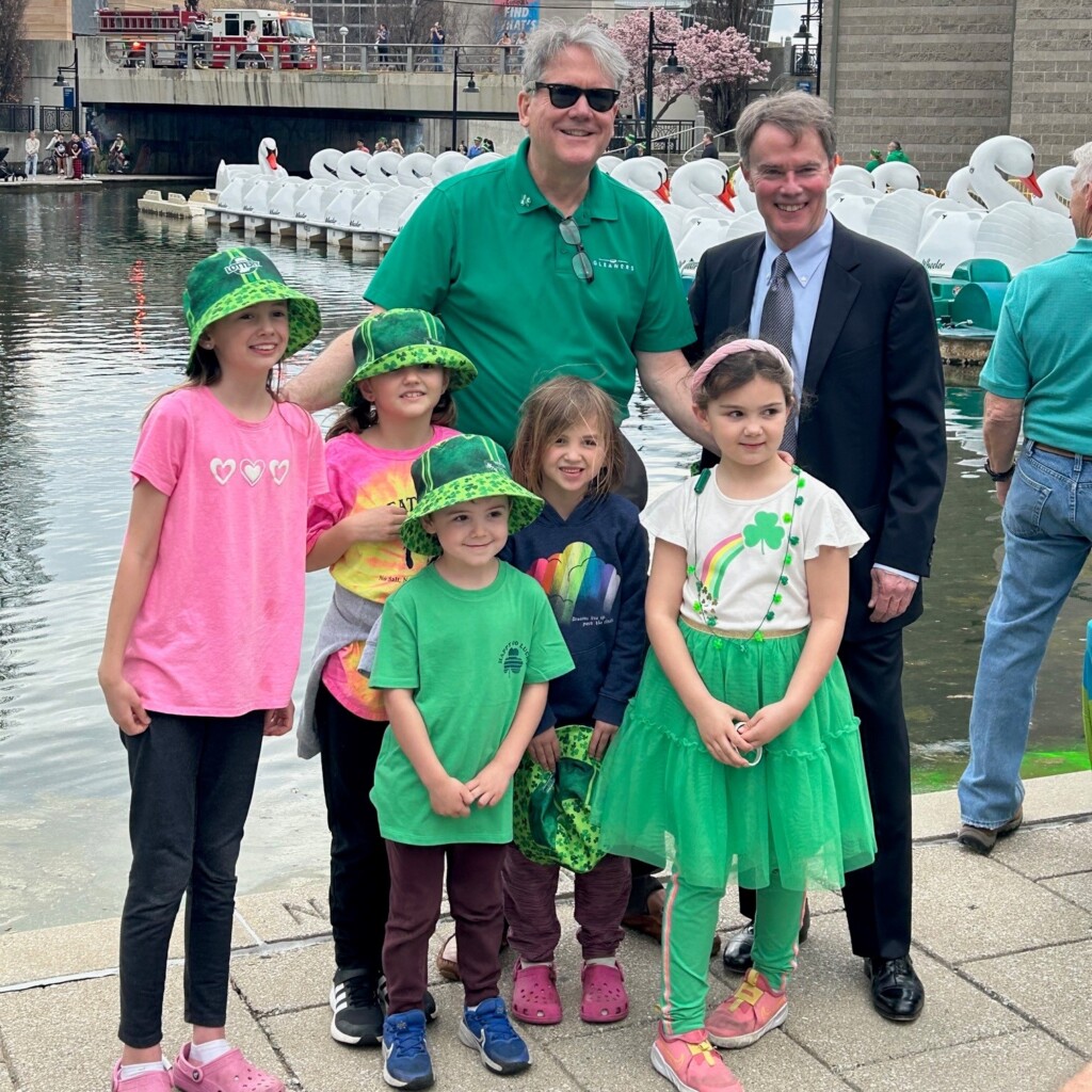 Gleaners President & CEO Fred Glass stands with his grandchildren and Indianapolis Mayor Joe Hogsett at the greening of the canal in downtown Indy on March 14, 2024.