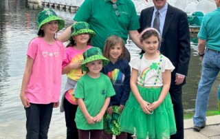 Gleaners President & CEO Fred Glass stands with his grandchildren and Indianapolis Mayor Joe Hogsett at the greening of the canal in downtown Indy on March 14, 2024.