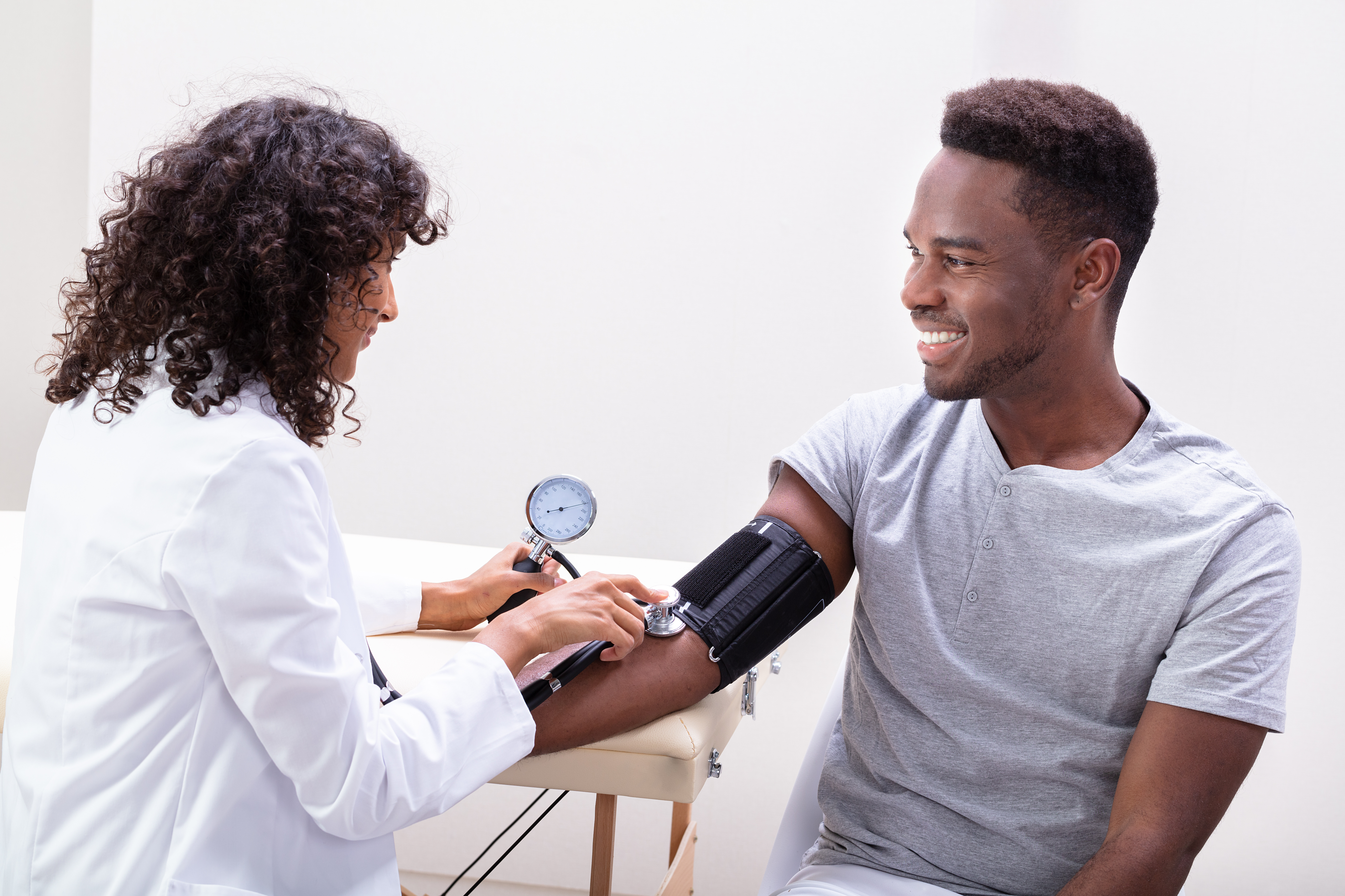 Additional Assistance Close-up Of Female Doctor's Hand Checking Blood Pressure