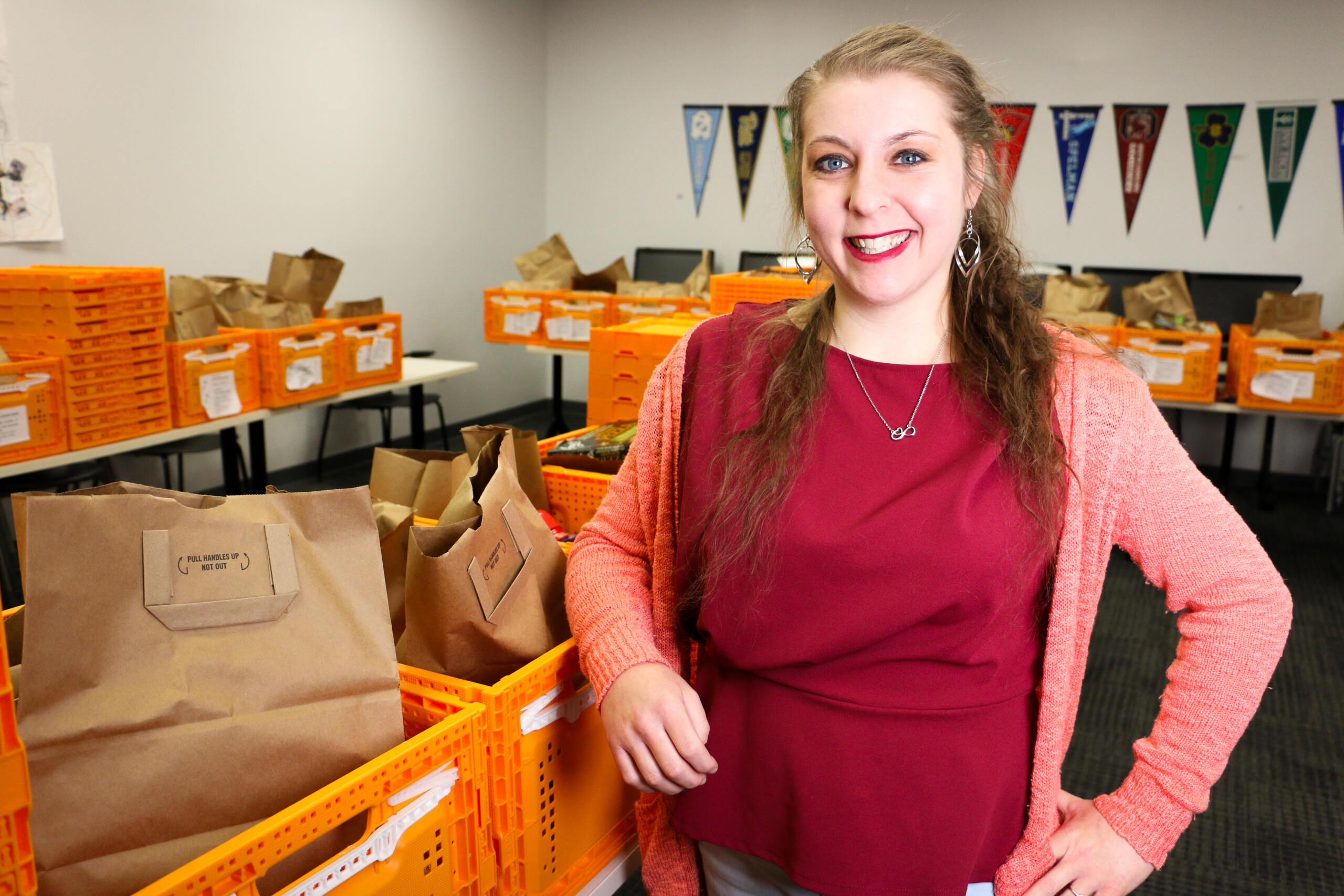 Courtney Caldwell, a life coach at The Excel Center stands with Gleaners2Go orders for her students, who pick up the groceries when they go to class.