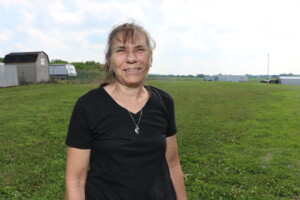 A woman wearing a black shirt poses for a photo while visiting a Gleaners mobile pantry in Boone County.